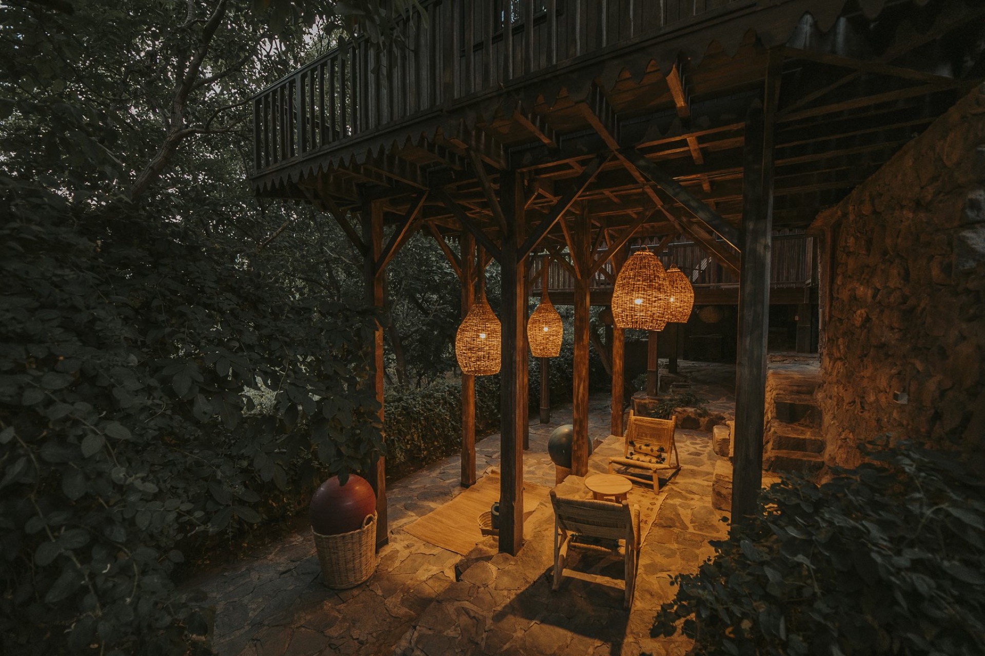 Lanterns glowing in the Douar Samra garden at dusk