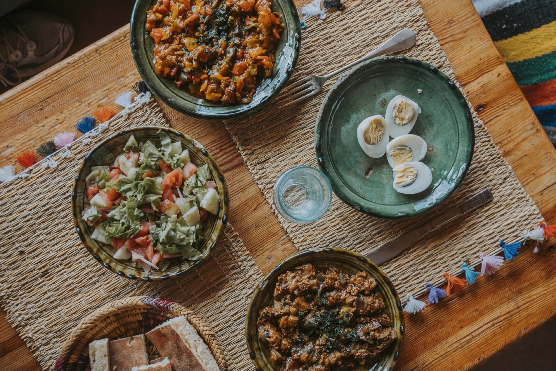 Berber dishes seen from above, arranged on a woven mat