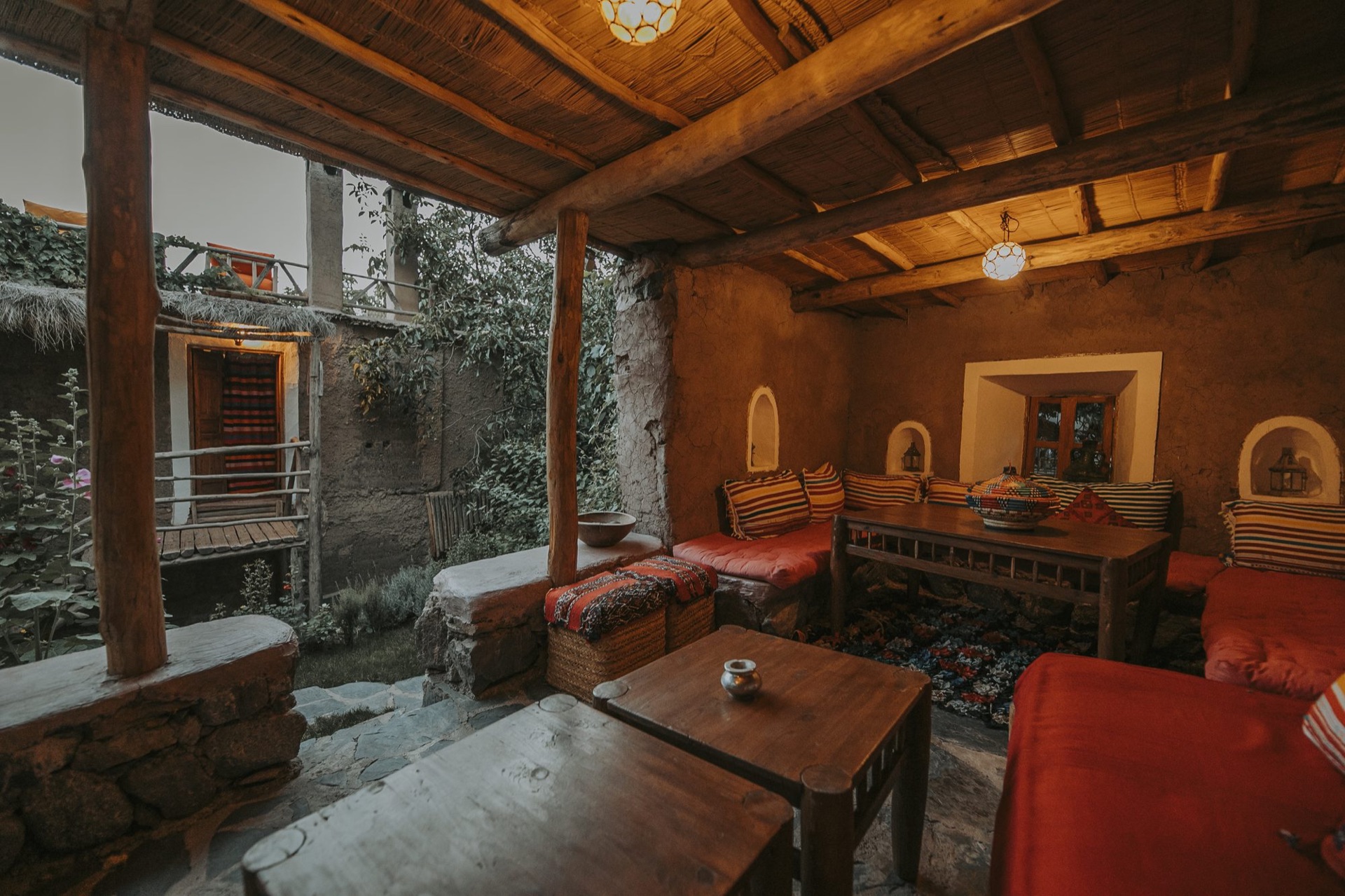The Douar Samra lounge and table lit by woven lanterns